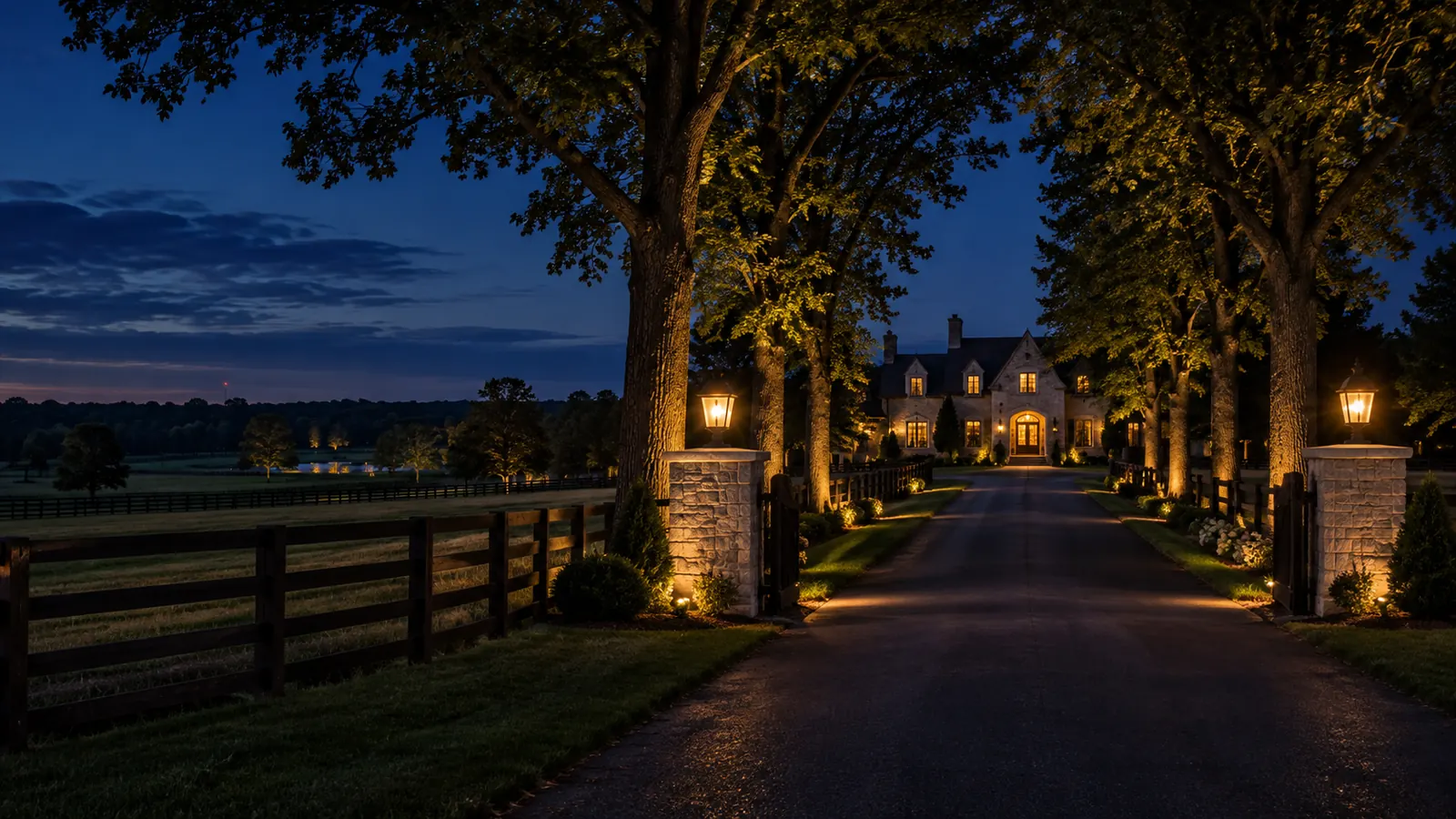 A tree-lined country lane leading to a large estate home on a rural lot in Rural Oakville at dusk